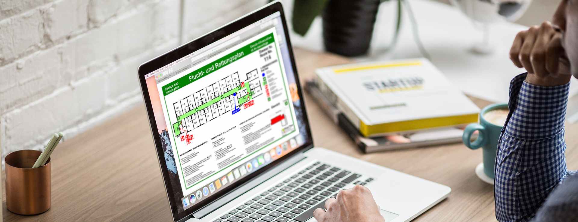Mann erstellt gerade auf einem Laptop einen Flucht- und Rettungsplan